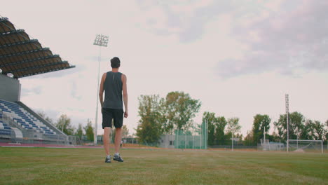 Slow-motion:-a-Male-athlete-at-the-stadium-concentrates-and-prepares-to-do-a-javelin-throw.-Attitude-and-serious-expression.-Goes-around-collecting-spears.-Training-of-a-javelin-thrower